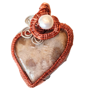 Heart shaped wire wrapped Petoskey pendant with fresh water pearl.